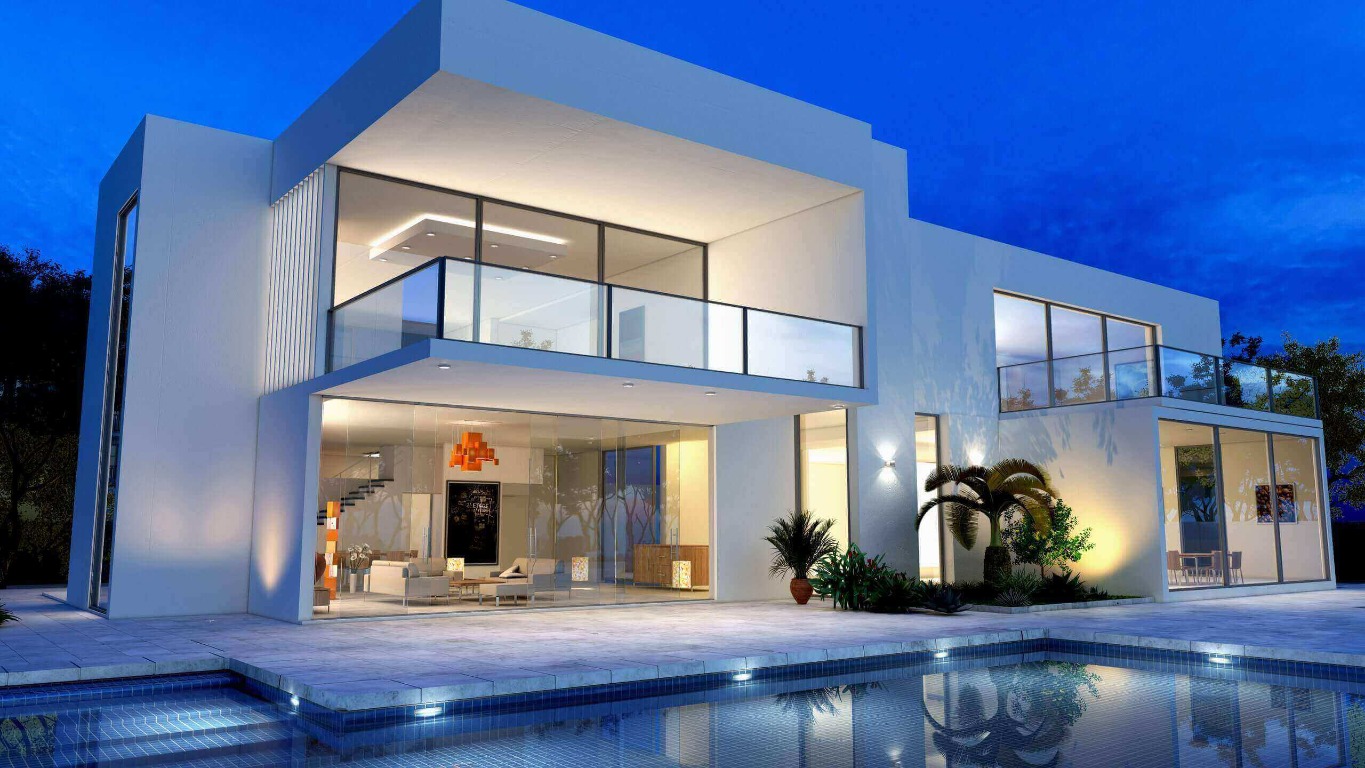 Large white contemporary villa with a swimming pool at twilight